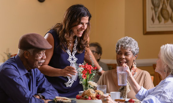 Residents and staff enjoying a meal together