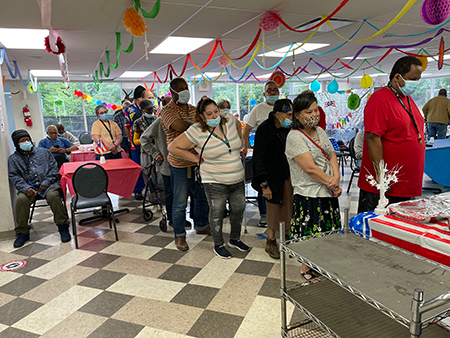 Residents participating in a festive indoor activity.
