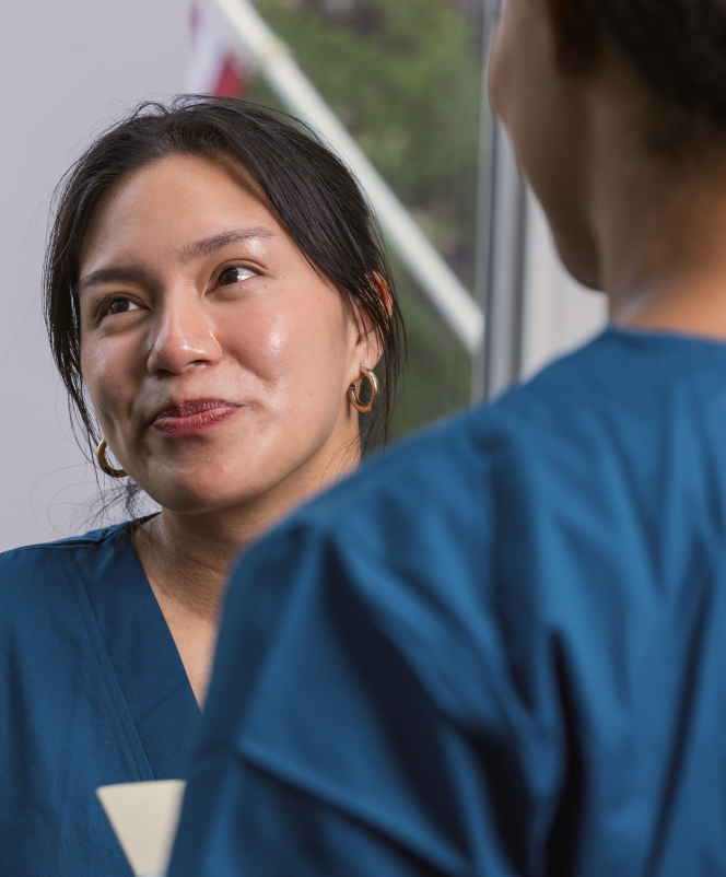 Healthcare staff engaging in conversation indoors