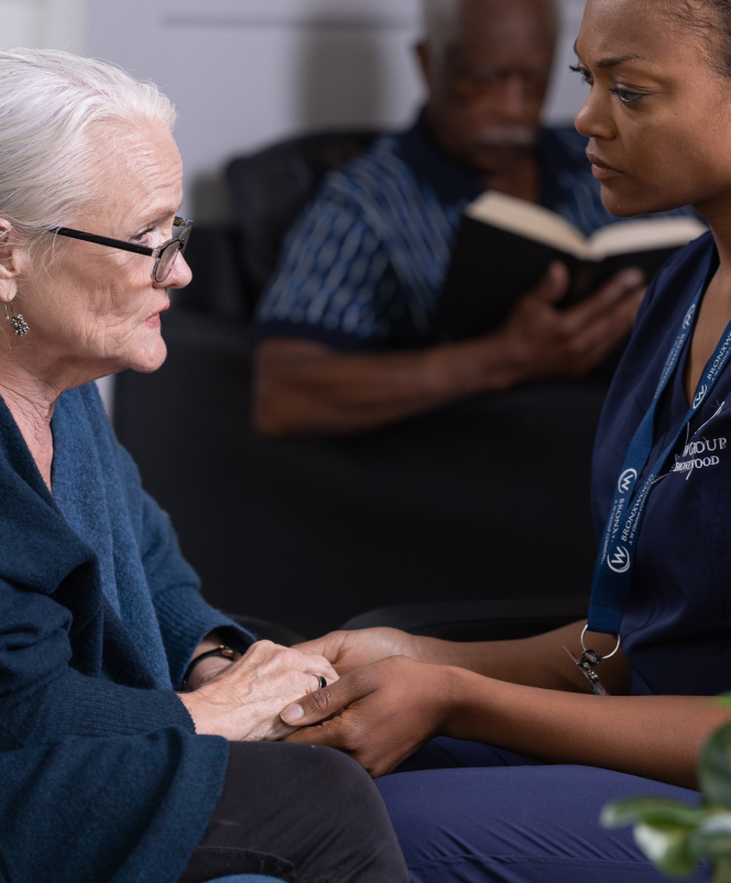 Caregiver and resident in a compassionate interaction