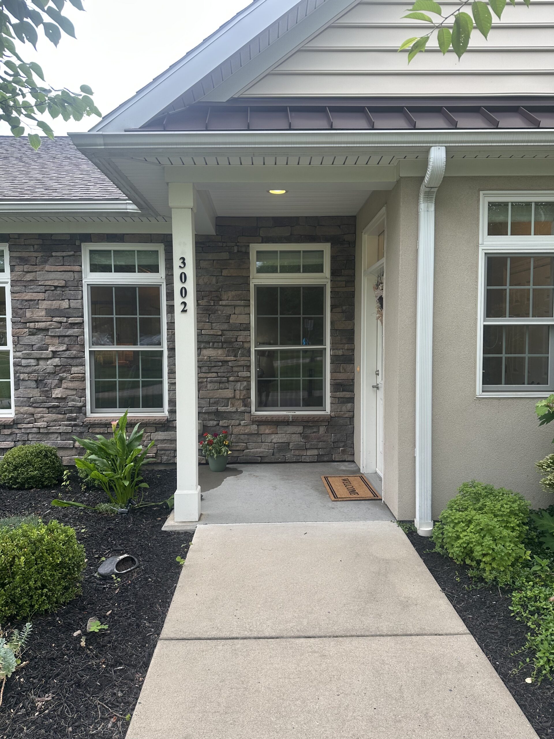Front entrance of a senior living facility with landscaped area