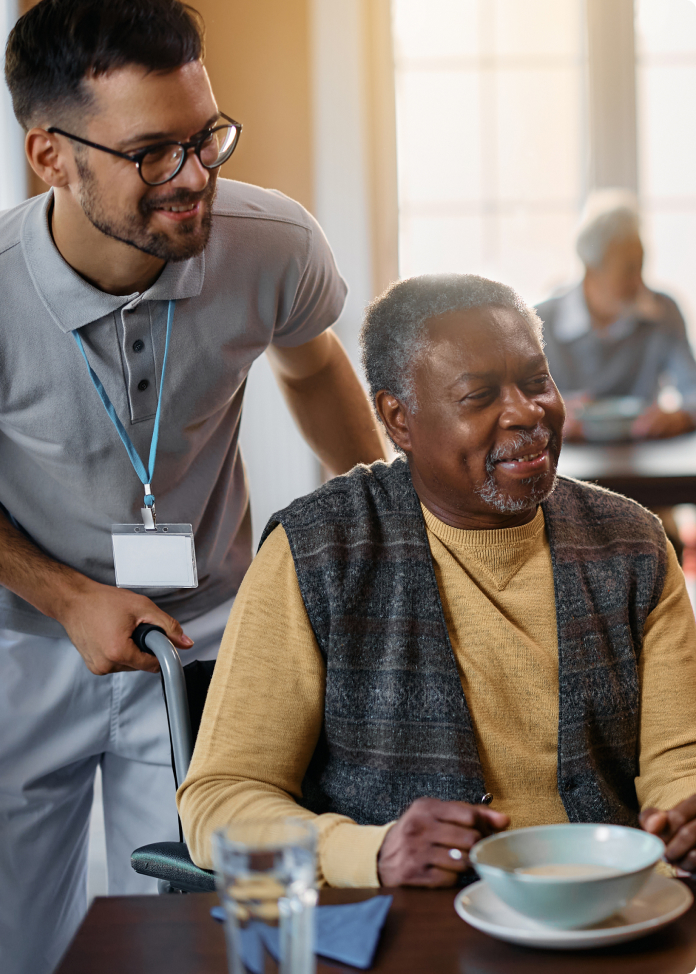Staff assisting a resident with a meal