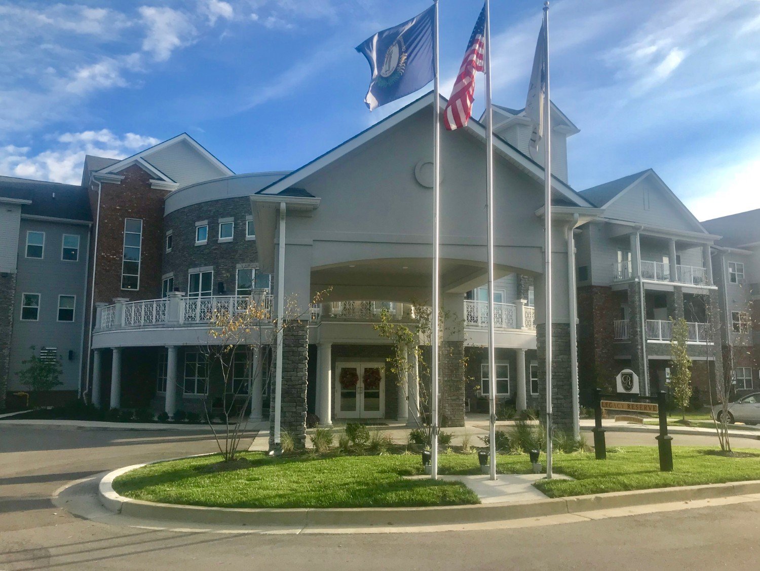 Exterior view of the facility entrance with flags