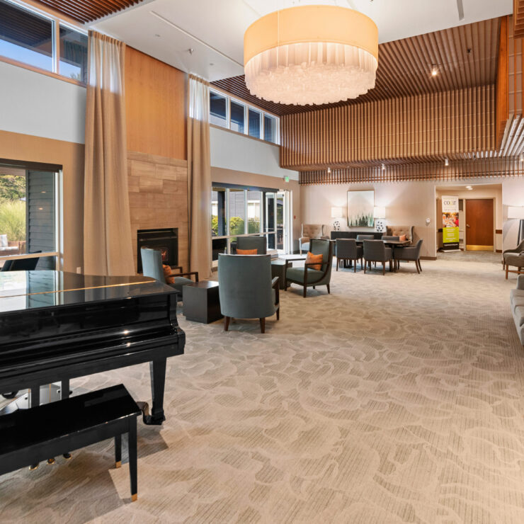 Bright common area with seating and a piano