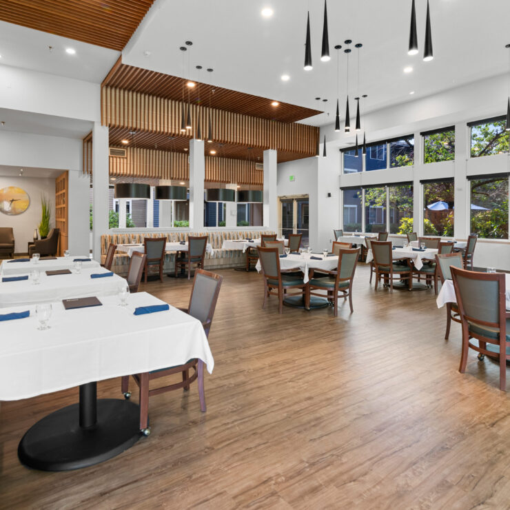 Modern dining room with tables set for dining
