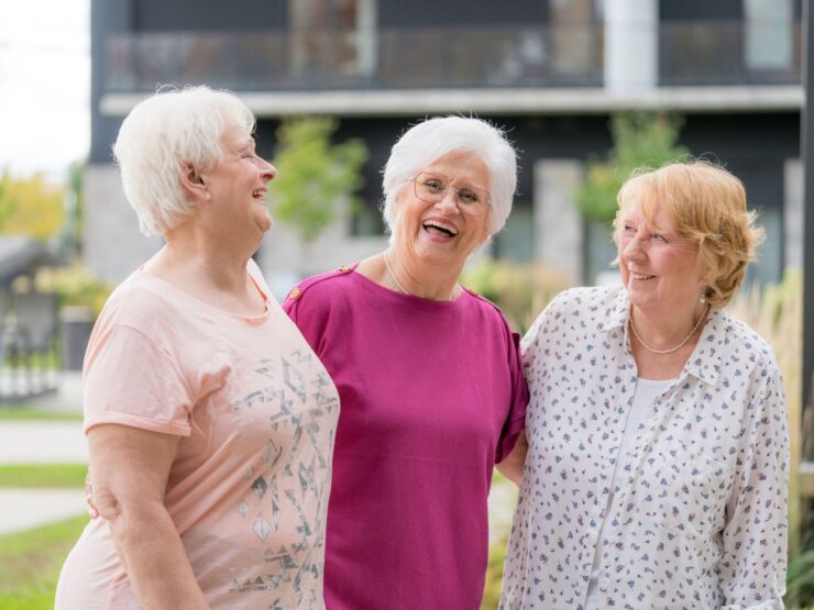 Three smiling women enjoying time outdoors