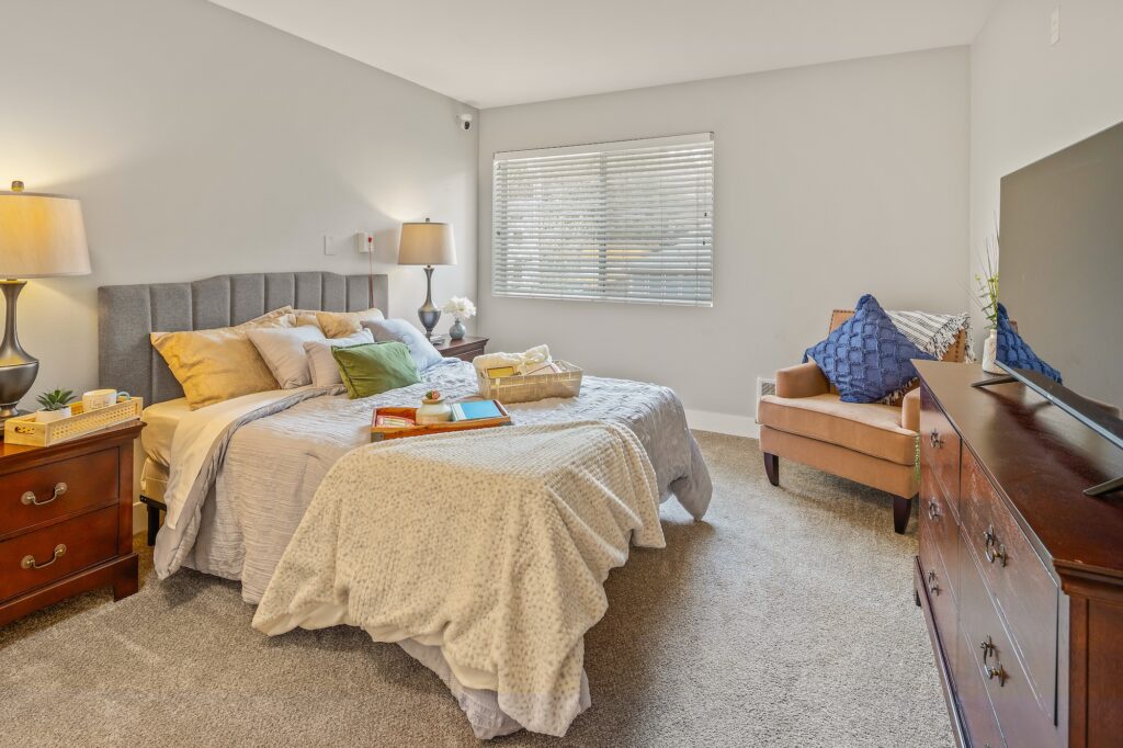 Cozy bedroom with a bed, chair, and decorative accents