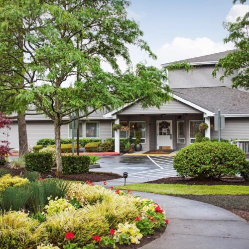Exterior view of the facility entrance surrounded by landscaping