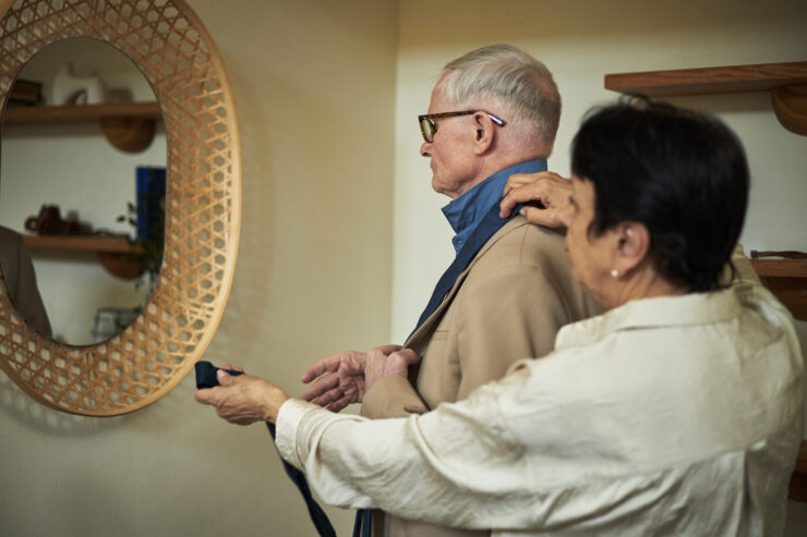 A caregiver assisting a resident with clothing