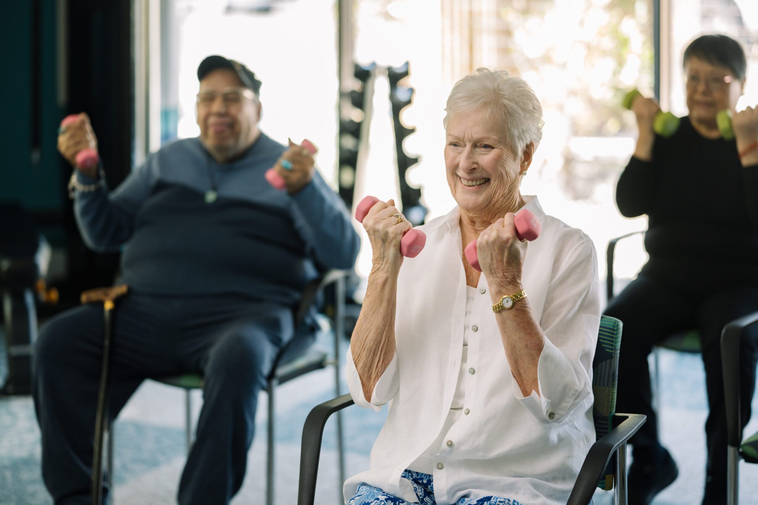 Residents participating in a chair exercise class