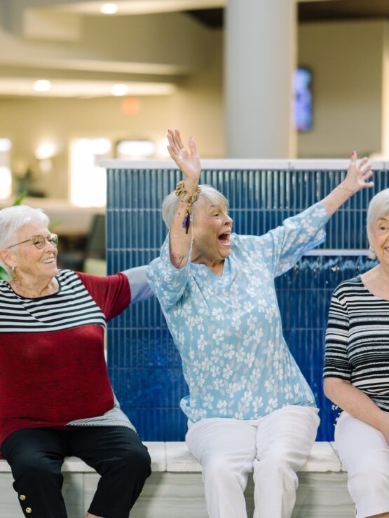 Three residents joyfully celebrating together