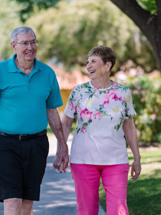 Elderly couple enjoying a walk in a garden