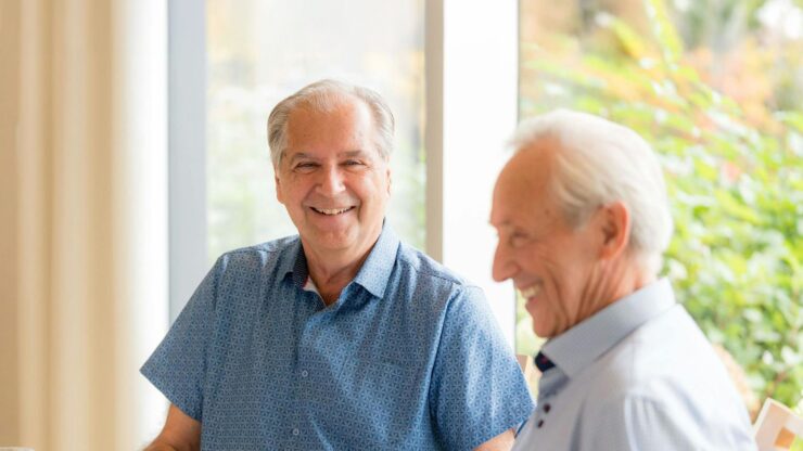 Two seniors smiling and enjoying each other's company