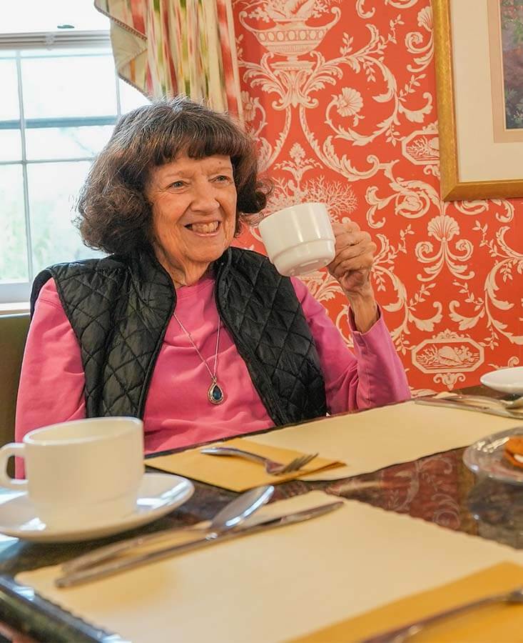 Resident enjoying tea in the dining area