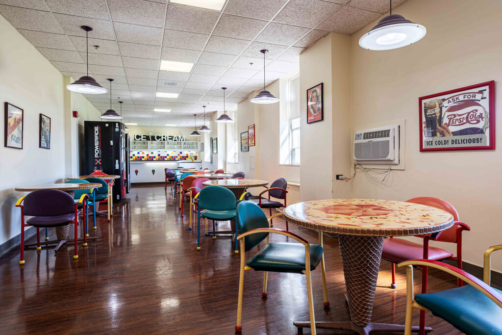 Bright common area with colorful chairs and tables