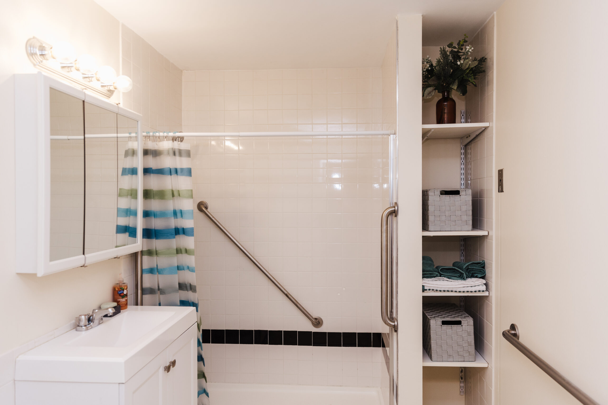 Bathroom interior with grab bars and towels