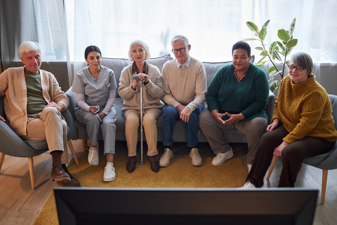 Residents enjoying a movie together in a common area