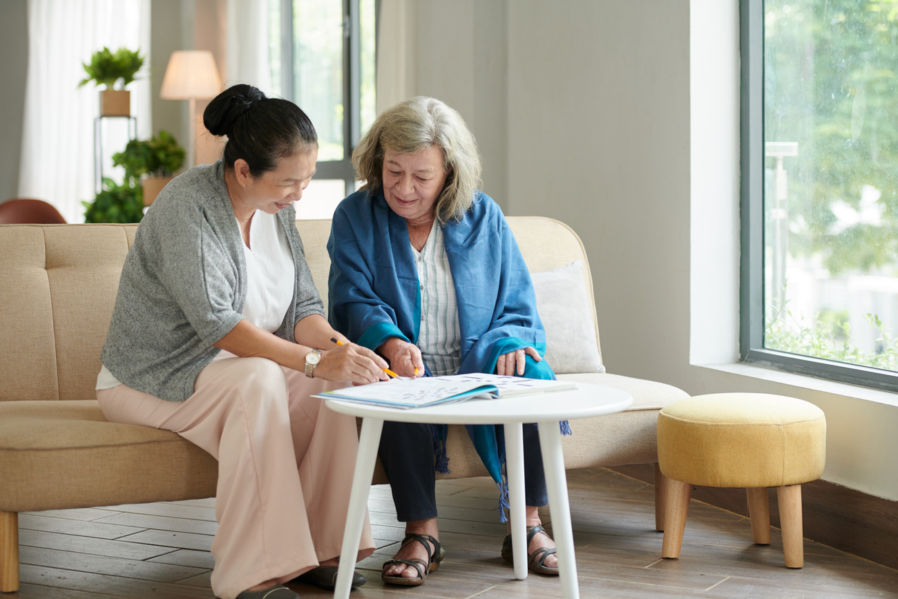 Two women engaged in conversation in a common area