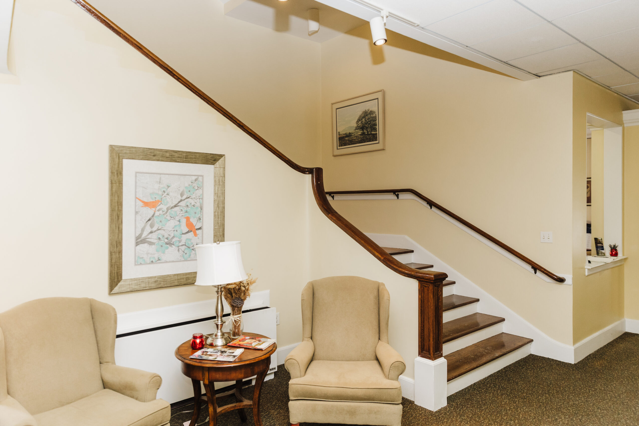 Interior seating area with staircase and artwork