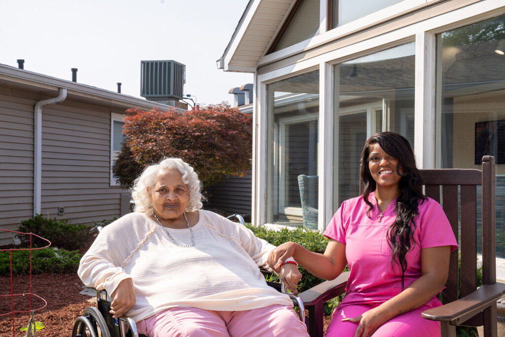 Resident and caregiver enjoying time in the garden