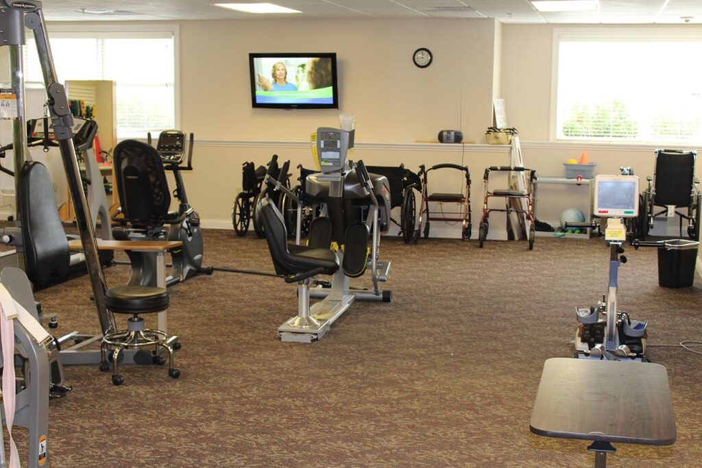 Interior view of a fitness area with equipment and residents' mobility aids