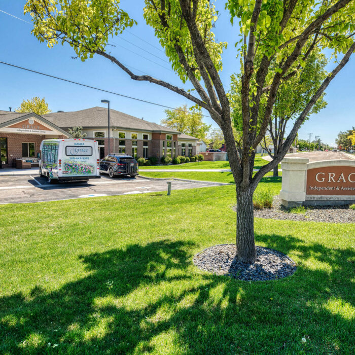 Exterior view of Grace Assisted Living facility with landscaping