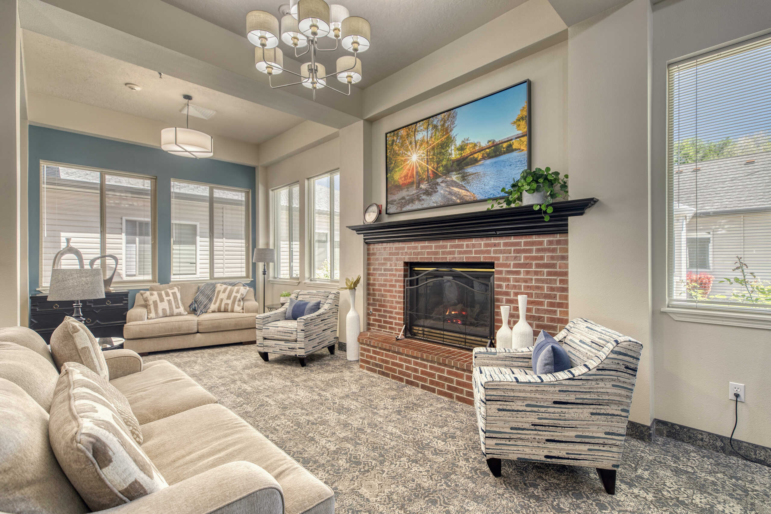 Bright common area with cozy seating and a fireplace