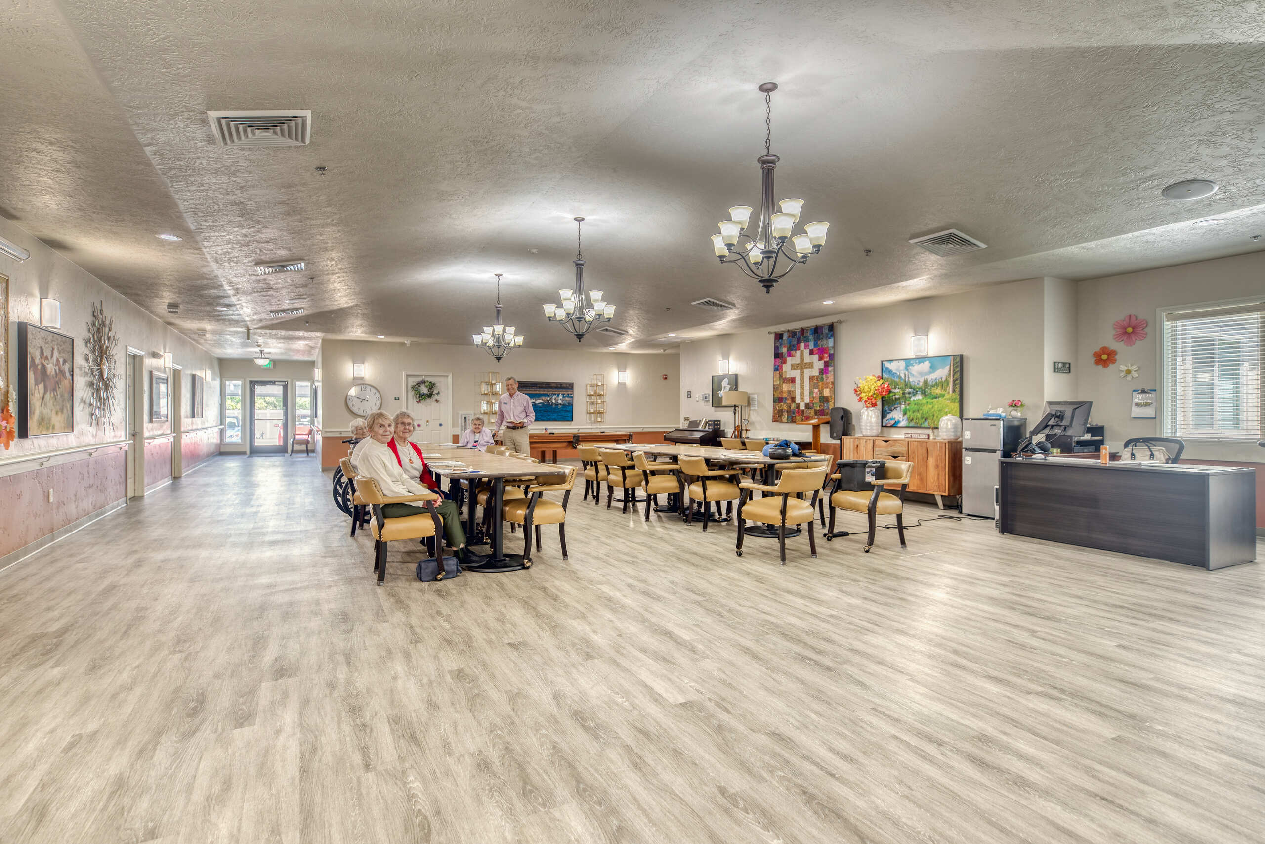 Bright interior dining room with residents and staff