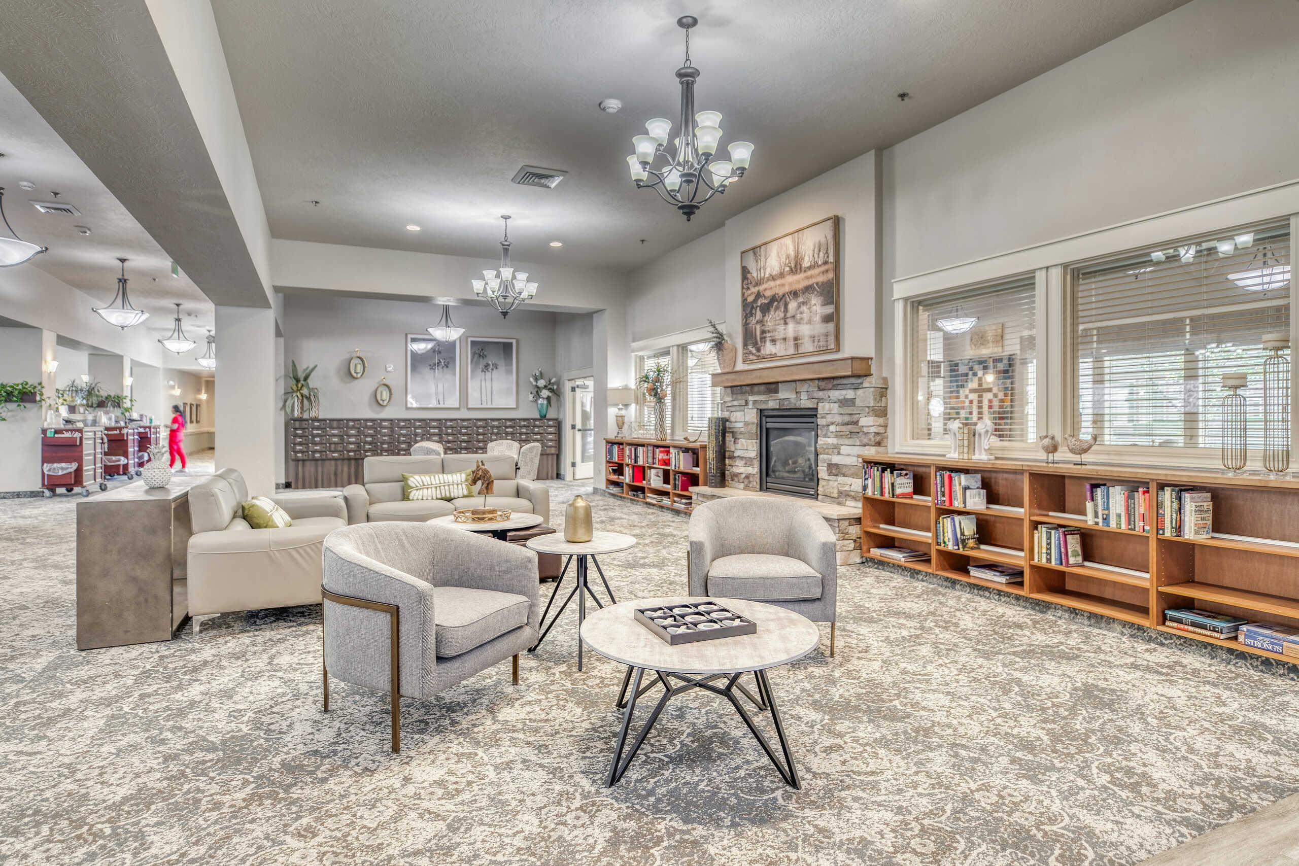 Bright common area with comfortable seating and shelves