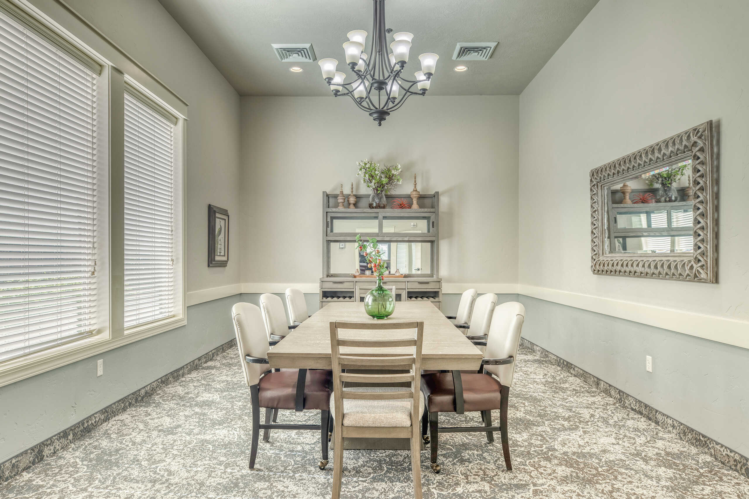 Well-lit dining room with a large table and chairs