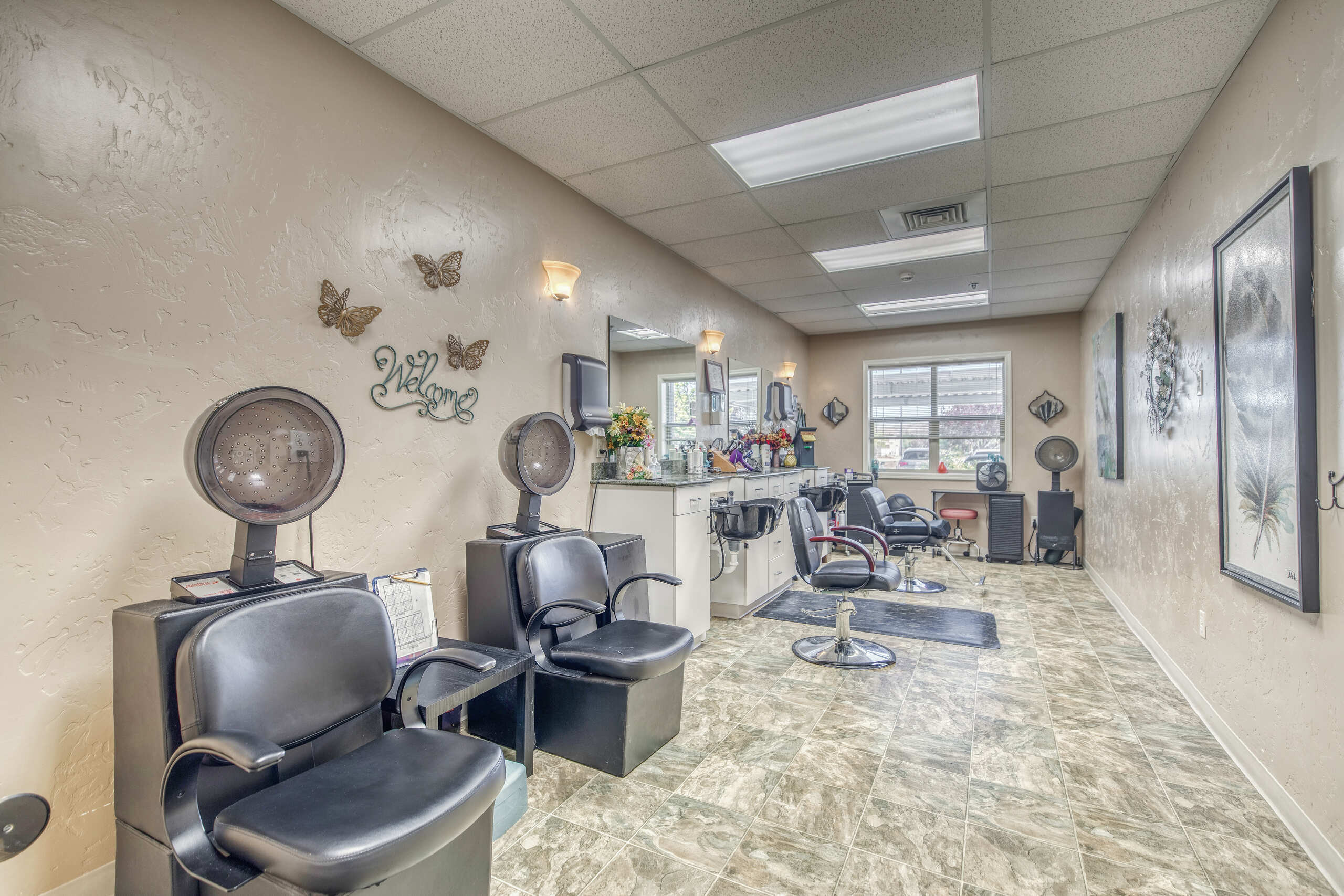 Beauty salon area with styling chairs and mirrors