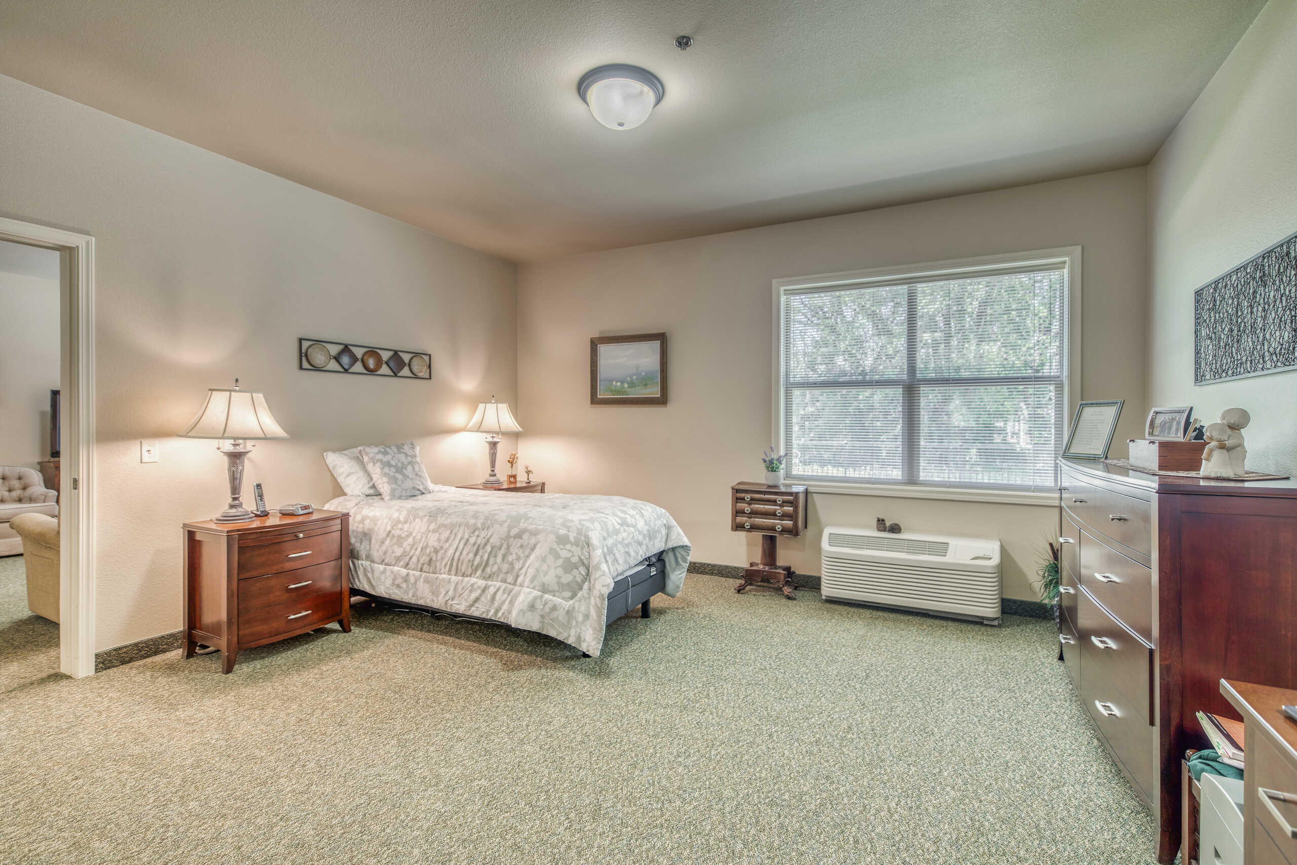 A cozy private resident room with a bed and furniture
