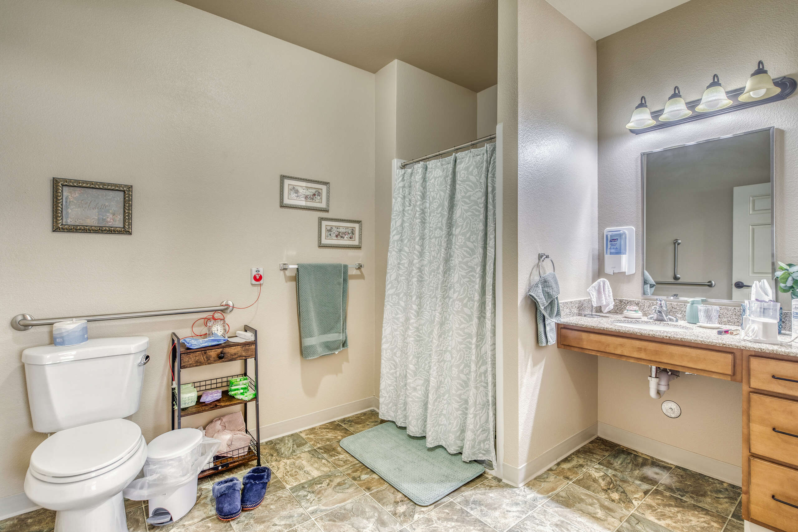 Well-lit bathroom area with shower and vanity