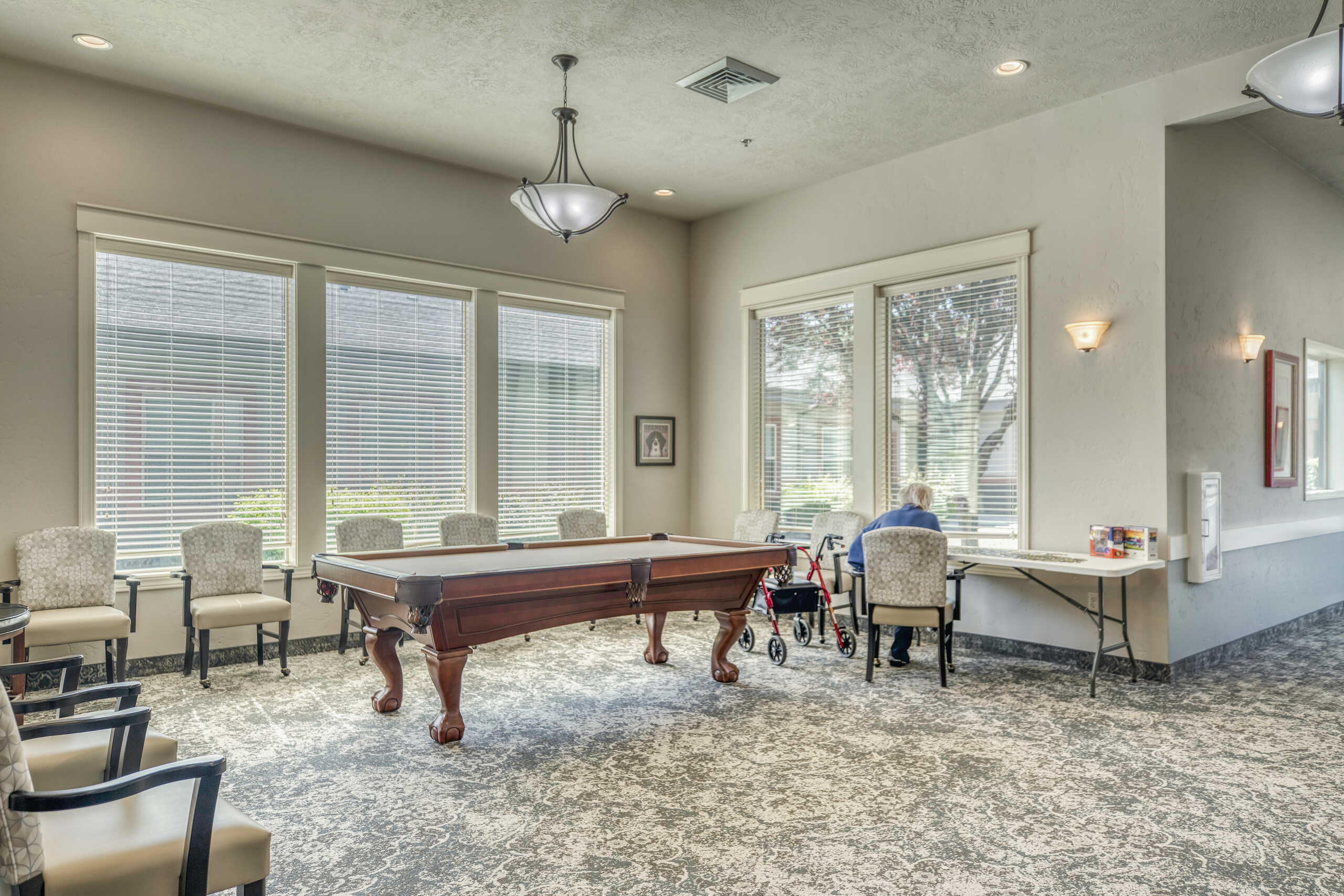 Residents enjoying the common area with a game table