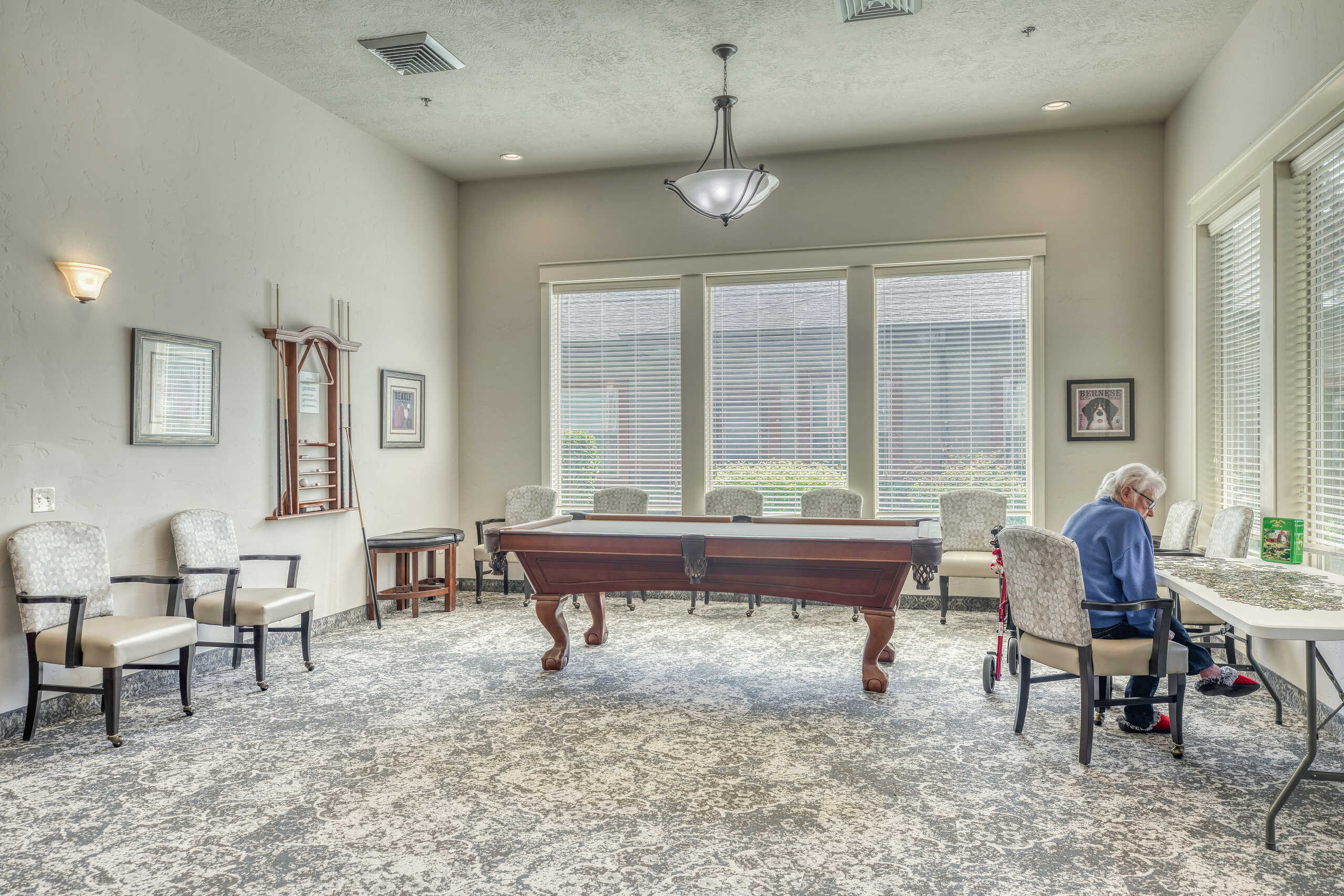 Common area with a resident engaged at a table