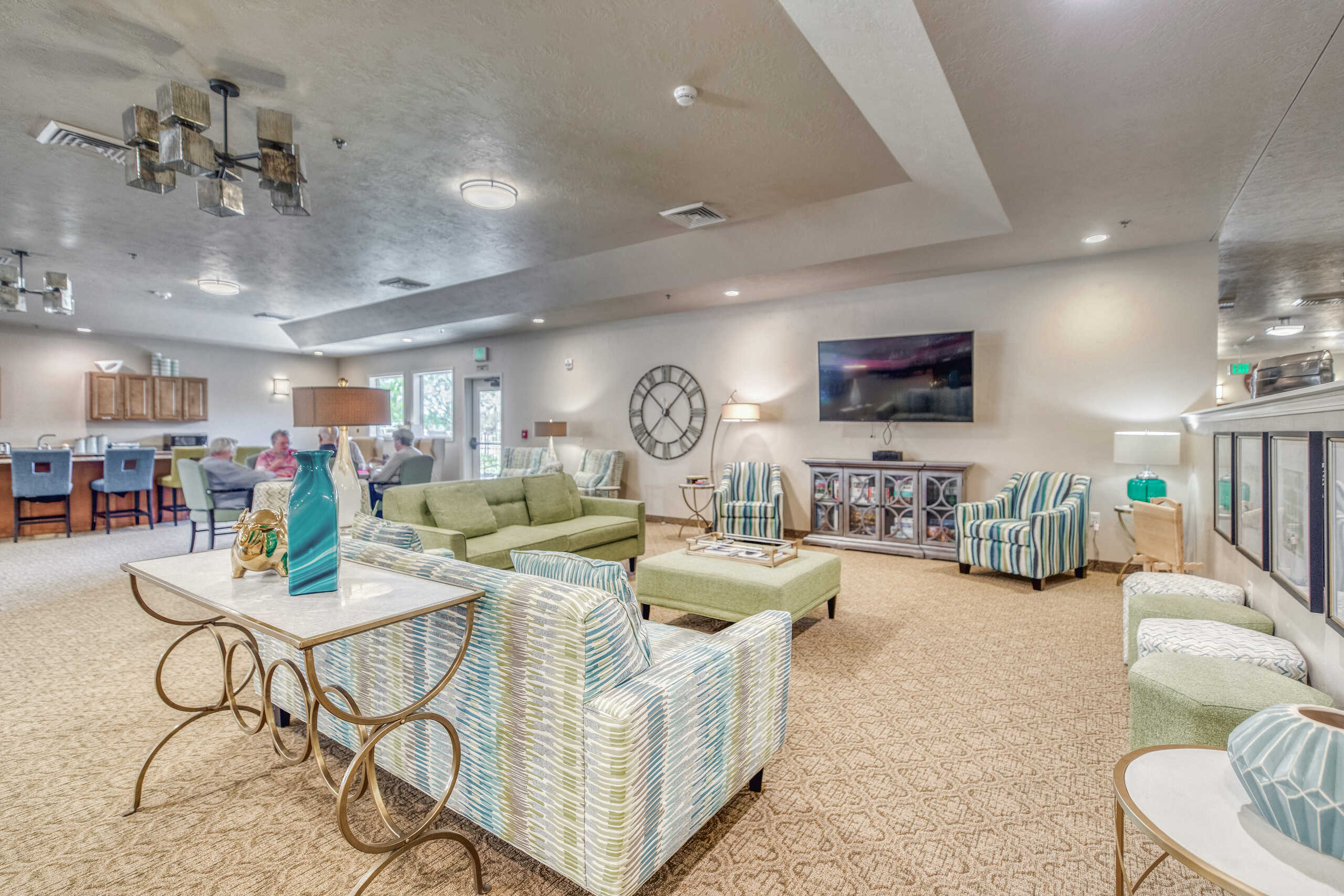 Bright common area with seating and residents.