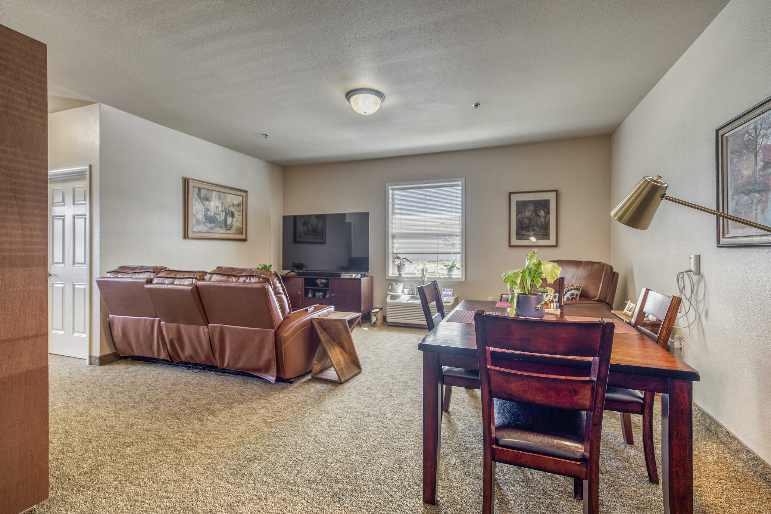 Cozy interior view of a living area with seating and dining table