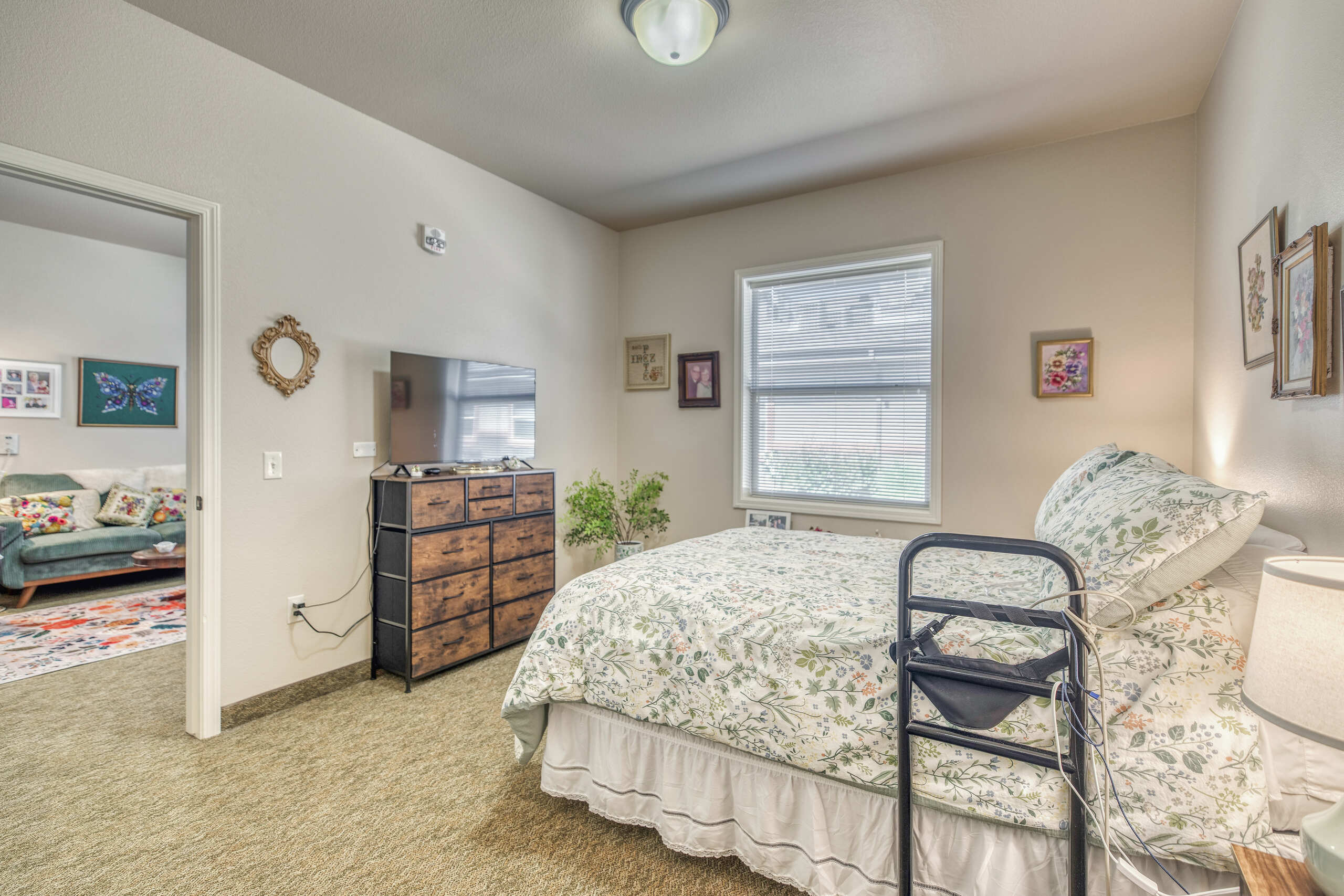 Comfortable private room with floral bedding and TV