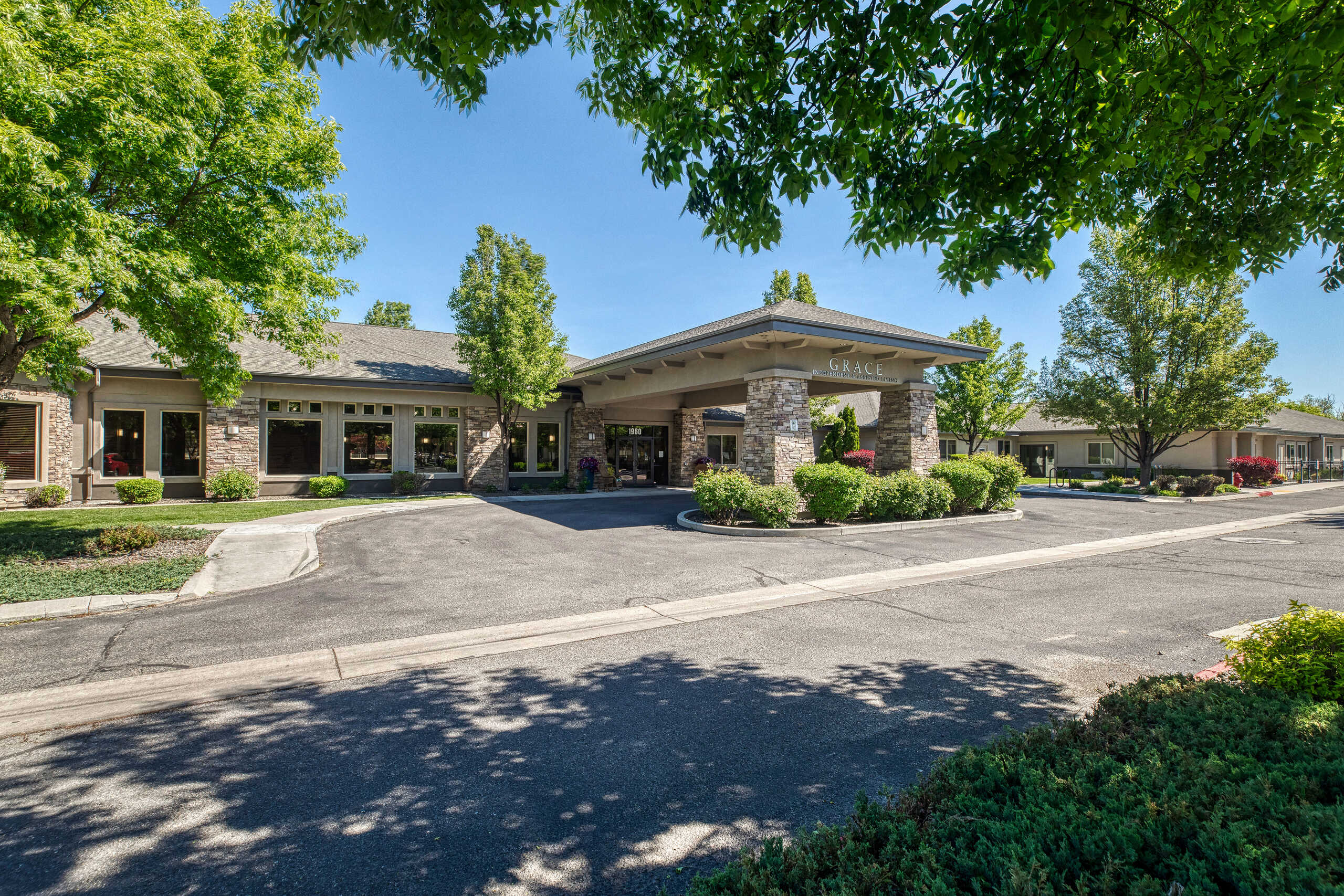 Exterior view of Grace Assisted Living facility with landscaping