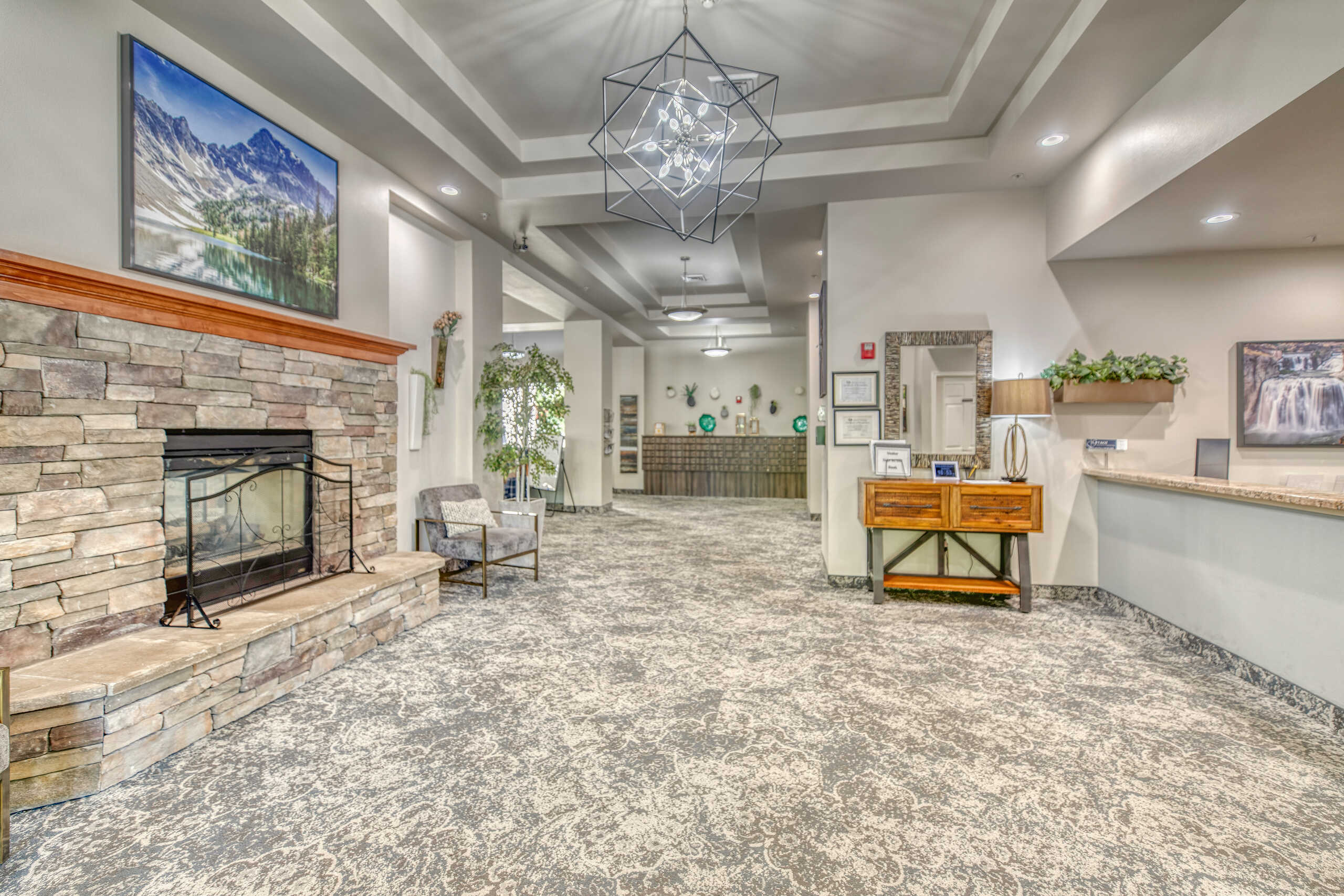 Bright interior common area with seating and a fireplace
