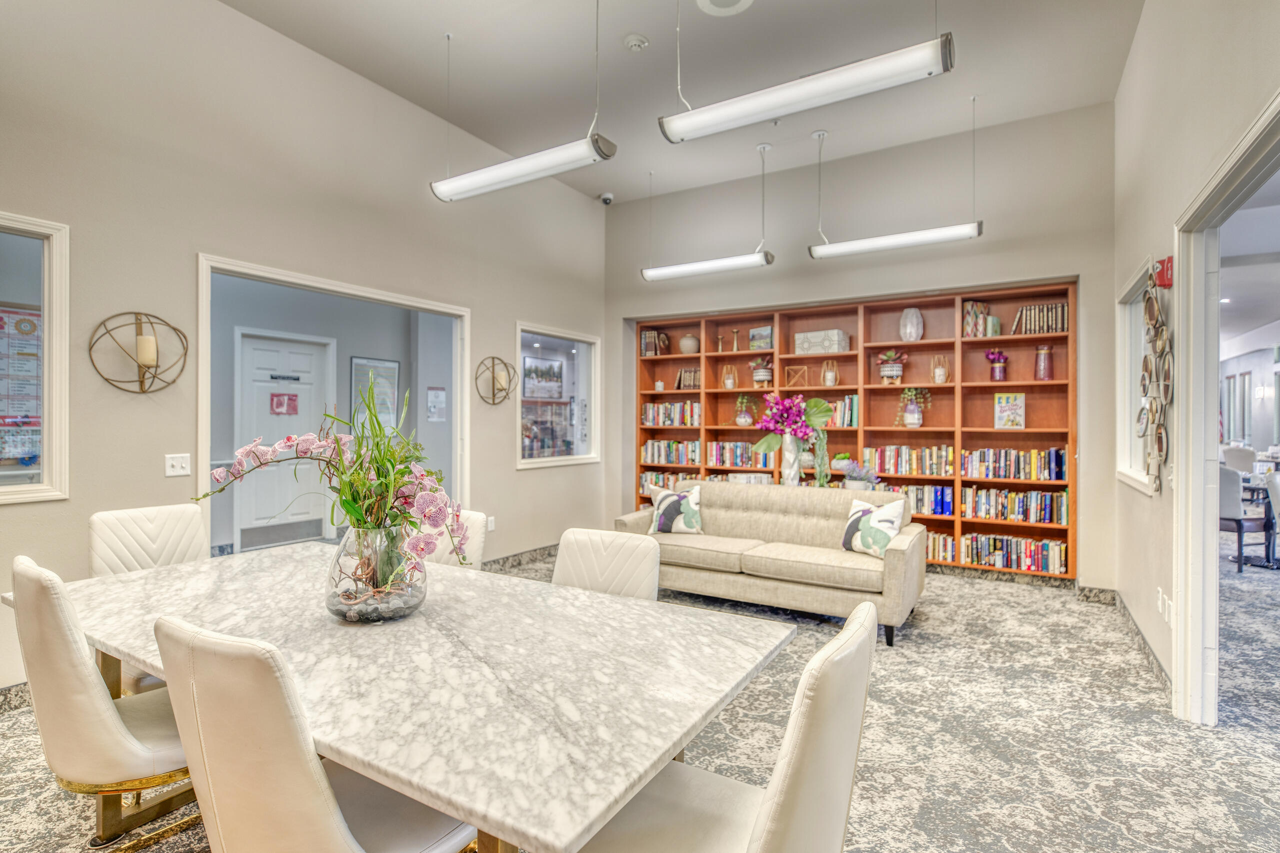Bright common area with bookshelves and a seating arrangement