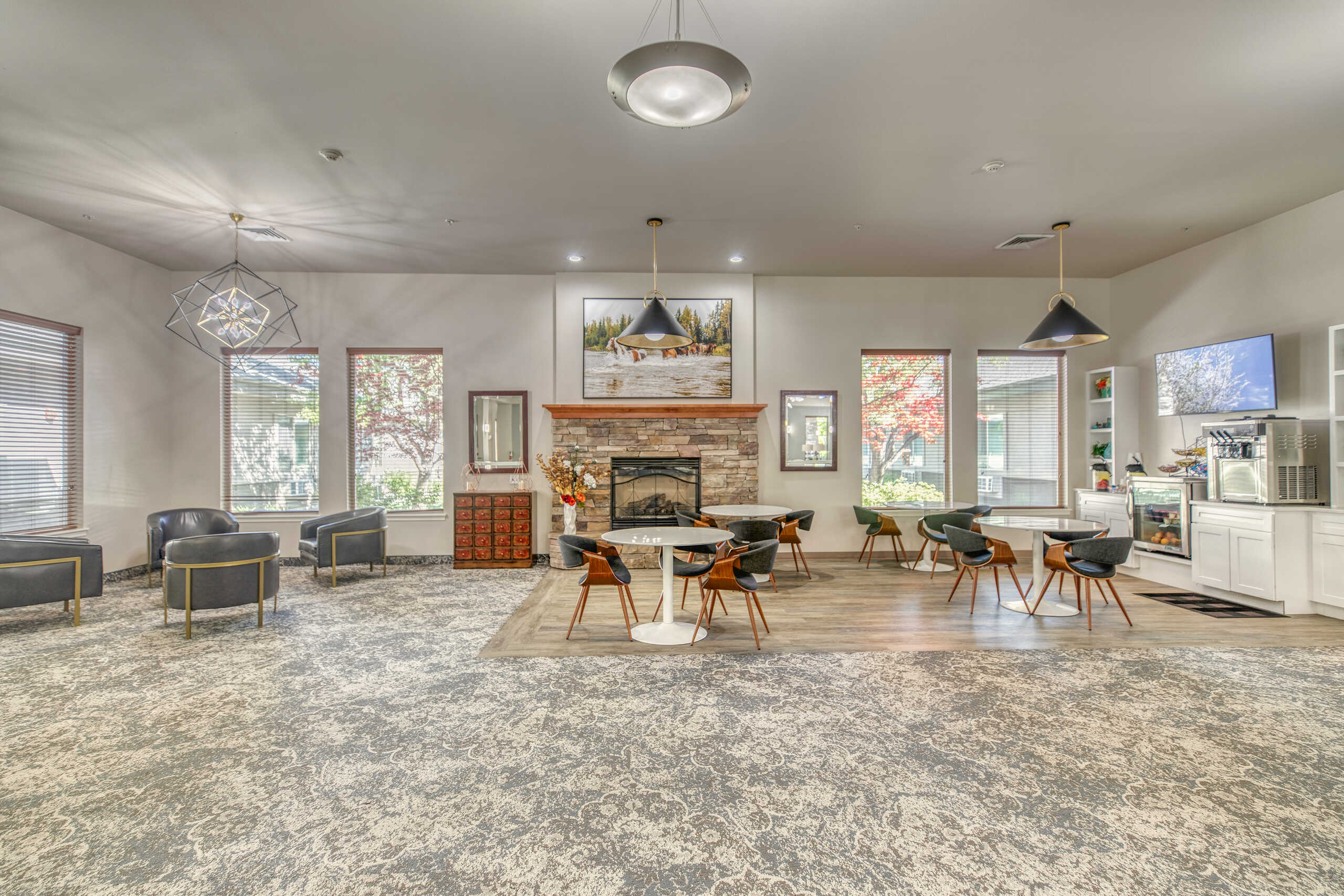 Bright common area with seating and a fireplace