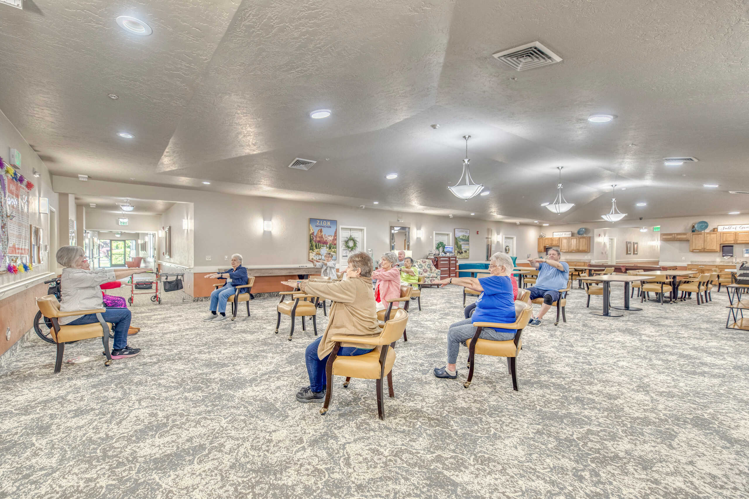 Residents engaging in a seated group activity in the dining area.
