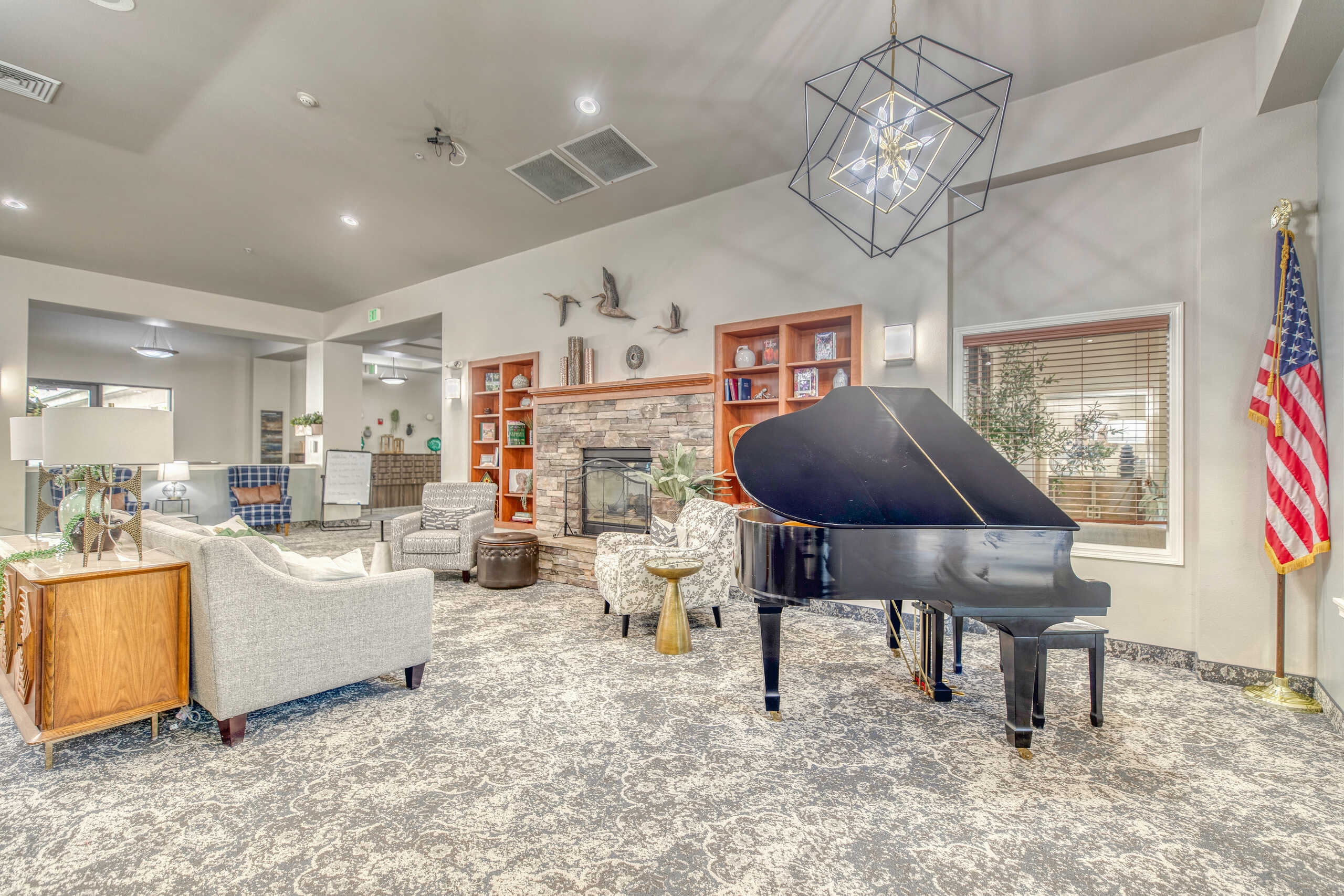 Common area with a grand piano and seating.