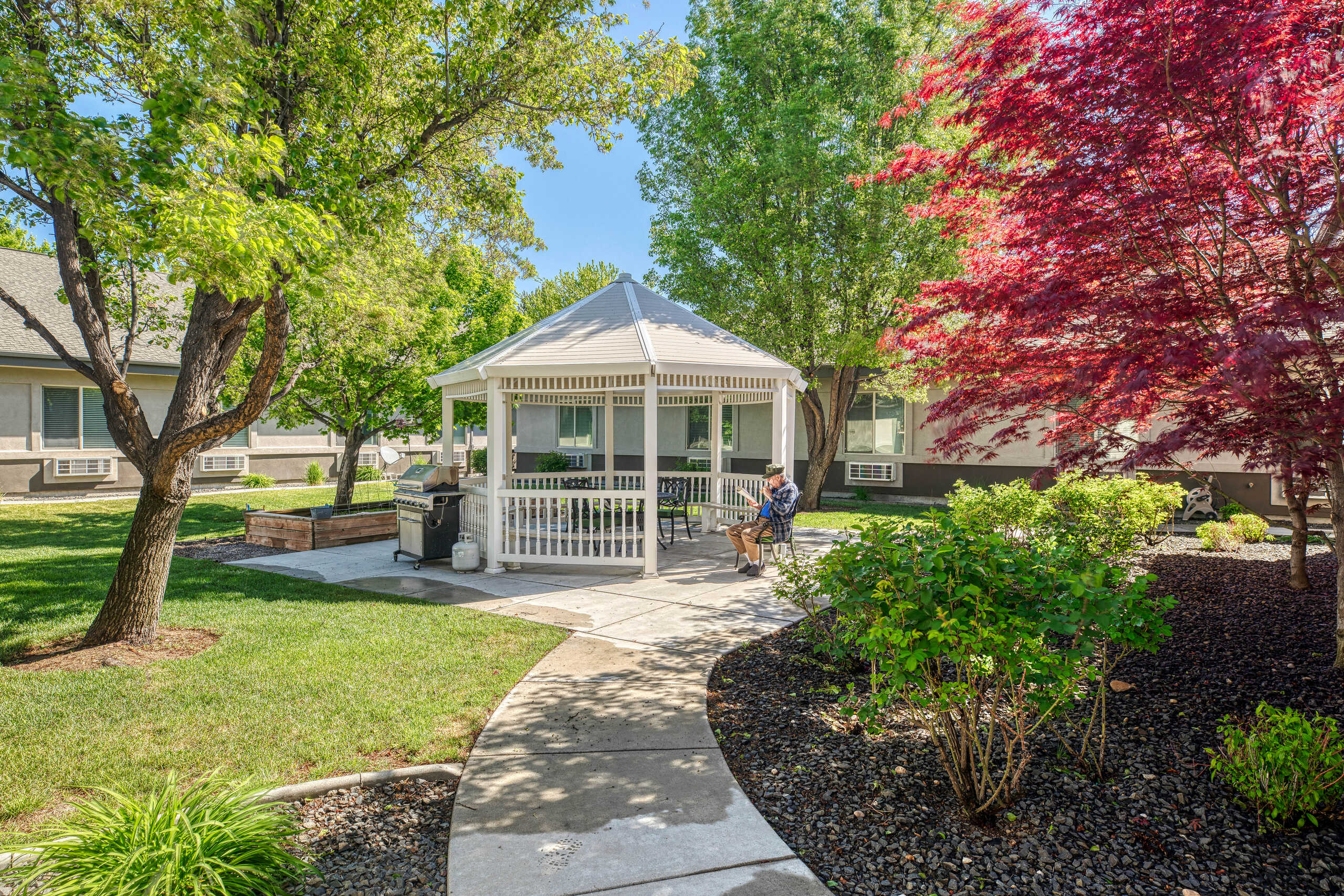 Resident relaxing in a gazebo in the garden