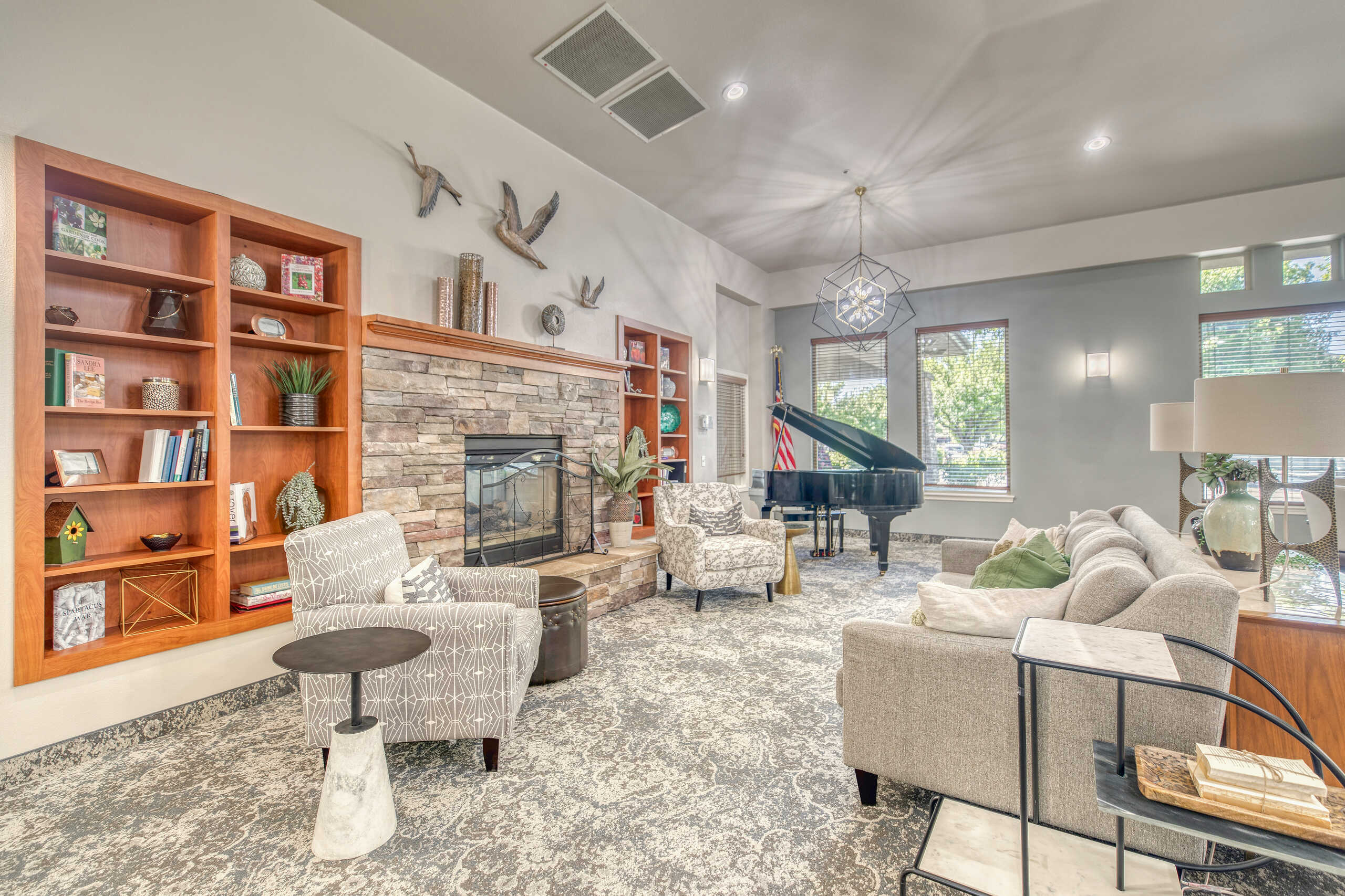 Bright common area with seating and a piano