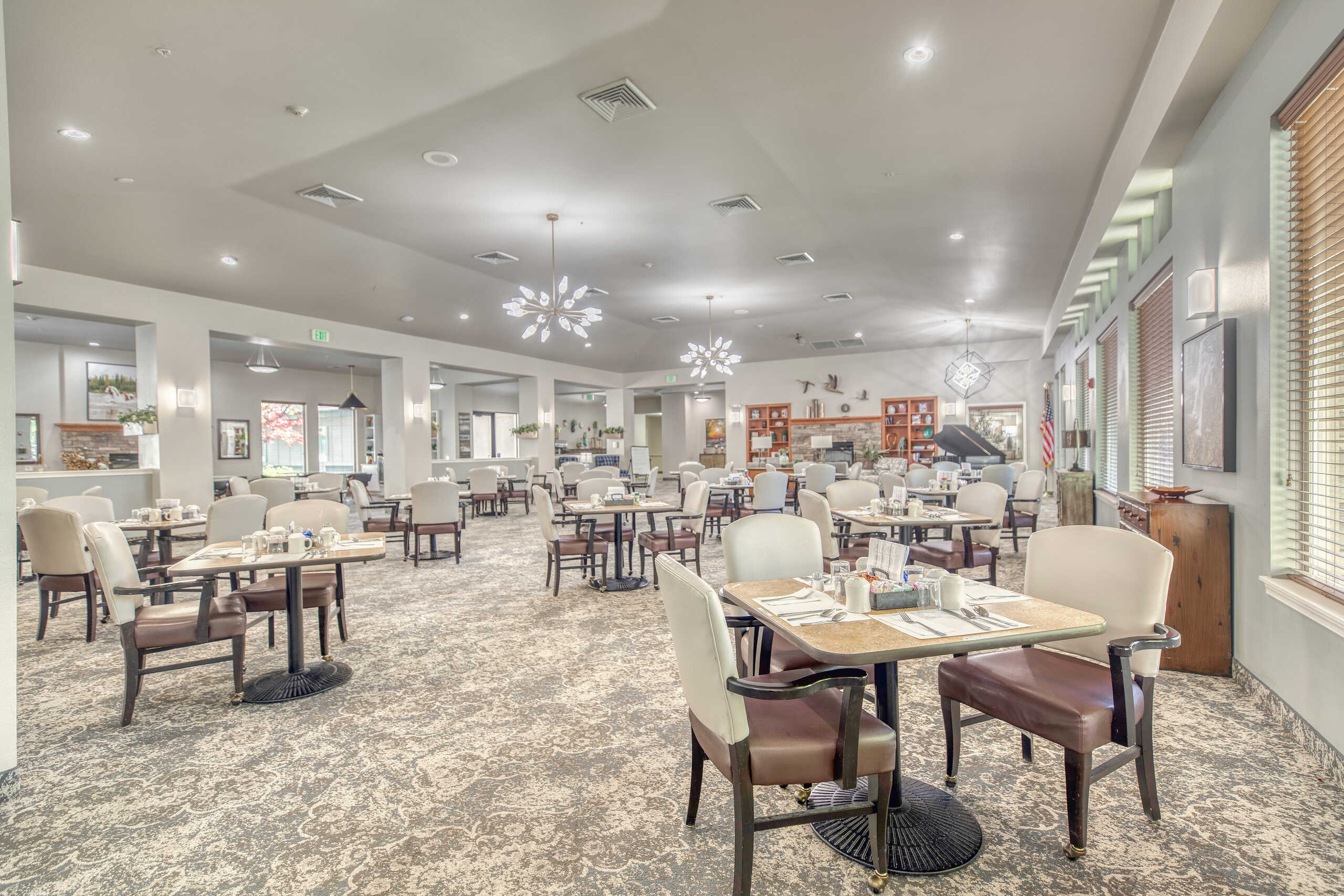 Dining area of a senior living community with tables and chairs