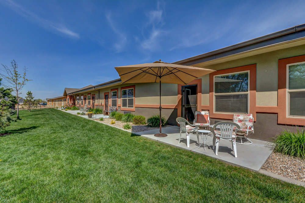 Outdoor patio area with seating under umbrellas