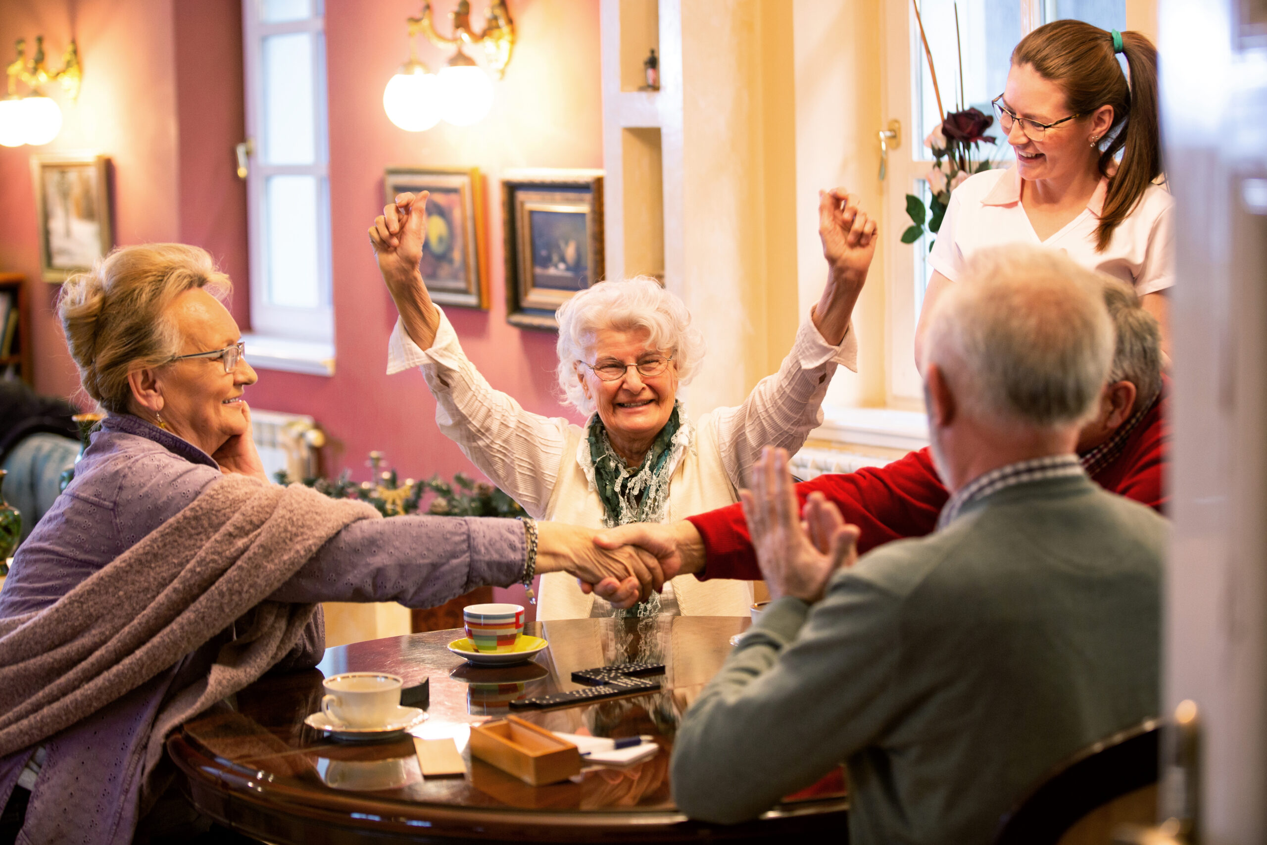 Residents joyfully participating in an activity at a table