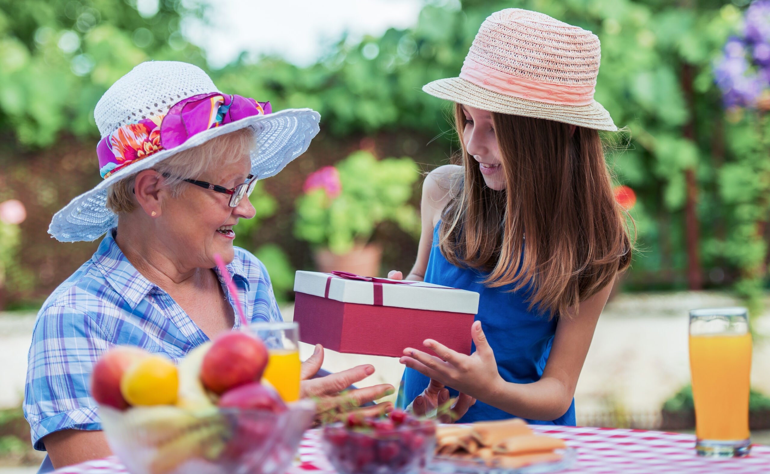 Resident and child exchanging a gift outdoors